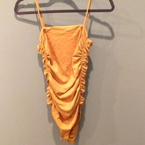 Free people peach color, size small bodysuit with ruching on the side